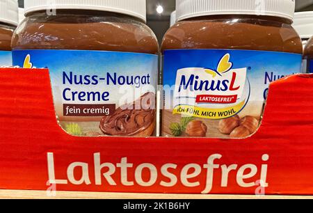 Viersen, Germany - June 9. 2022: Closeup of jars MinusL organic lactose free hazelnut nougat spread in shelf of german supermarket Stock Photo