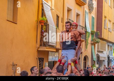 CAMBRILS, SPAIN - SEPTEMBER 04.2022: Castells Performance, a castell is a human tower built traditionally in festivals within Tarragona, Catalonia Stock Photo