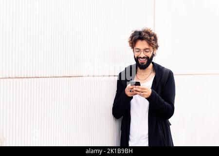 smiling young man talking on mobile phone Stock Photo