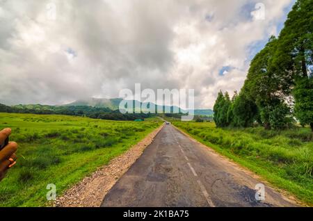 The road to Mawsynram, East Khasi Hills, Meghalaya, India, disappearing into the horizon. Stock Photo