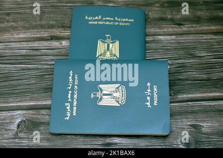 Egyptian passport isolated on wooden background, Arab republic of Egypt's passport with the republican golden eagle on its cover and king Tutankhamun Stock Photo