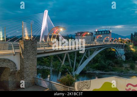 Podgorica, Montenegro - June 4, 2022: Night view on pedestrian Moscow bridge over Moraca river. Stock Photo