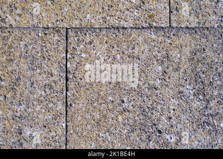 Big wall facing tile made of gray stone, texture, outdoor, old textured building facade surface, grey ceramic tile made of grungy rock, grunge backgro Stock Photo