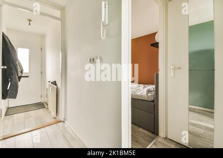 Interior of narrow corridor with telephone and radiator in daylight Stock Photo