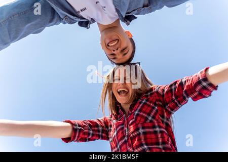 Cute couple posing while smiling from below Stock Photo