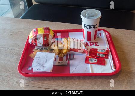 Pristina, Kosovo - June 5, 2022: KFC menu with spicy Sander Burger, Potato Wedges and Pepsi for drink. Stock Photo
