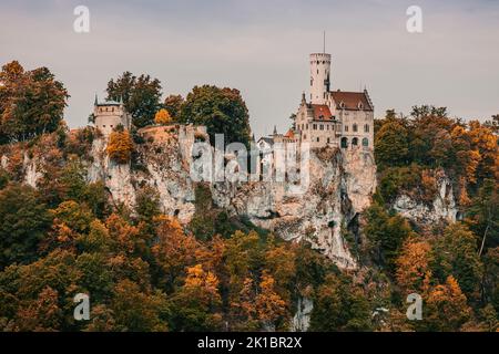 Autumn colours at Lichtenstein Castle, a privately owned Gothic Revival castle located in the Swabian Jura of southern Germany. It was designed by Car Stock Photo