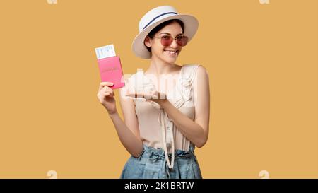 Vacation holiday. Best travel offer. Visa office. Summer tour. Stylish happy woman white hat sunglasses pointing foreign id tickets in hand looking at Stock Photo