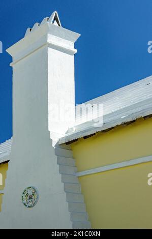 Bermuda Architecture Yellow House White Roof & Chimney Ceramic House Sign on Chimney Close Up Stock Photo