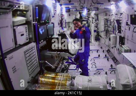 (220917) -- BEIJING, Sept. 17, 2022 (Xinhua) -- Screen image captured at Beijing Aerospace Control Center on Sept. 17, 2022 shows Shenzhou-14 astronaut Liu Yang, who is inside the core module, supporting her crewmates who have successfully exited the space station lab module Wentian to conduct extravehicular activities (EVAs). China's Shenzhou-14 astronauts have completed their EVAs, the China Manned Space Agency (CMSA) said on Saturday. At 1:35 p.m. (Beijing Time), Cai Xuzhe opened the hatch of Wentian's airlock cabin. By 3:33 p.m., both Cai and Chen Dong were outside. The pair returne Credit Stock Photo
