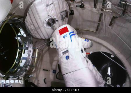 (220917) -- BEIJING, Sept. 17, 2022 (Xinhua) -- Screen image captured at Beijing Aerospace Control Center on Sept. 17, 2022 shows Shenzhou-14 astronaut Chen Dong returning to space station lab module Wentian after finishing extravehicular activities (EVAs). China's Shenzhou-14 astronauts have completed their EVAs, the China Manned Space Agency (CMSA) said on Saturday. At 1:35 p.m. (Beijing Time), Cai Xuzhe opened the hatch of Wentian's airlock cabin. By 3:33 p.m., both Cai and Chen Dong were outside. The pair returned to the lab module at 5:47 p.m. after about five hours of EVAs, accord Credit Stock Photo