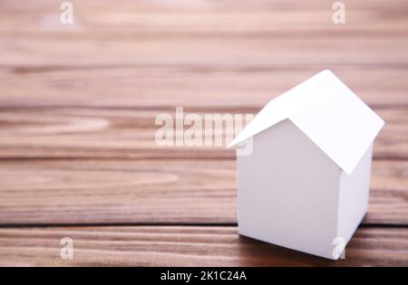 Concept of house in paper on wood. Horizontal composition. Top view. Stock Photo