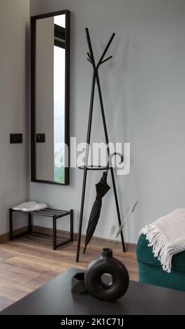 Modern clothes hanger stand and mirror in modern house Stock Photo