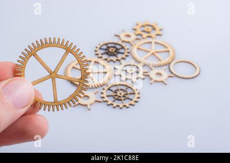 Hand holding gear wheels as the concept of mechanism Stock Photo