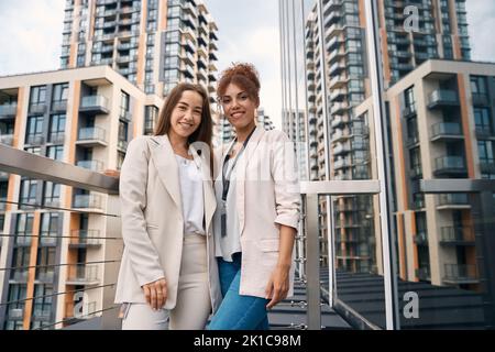 Smiling confident businesswomen posing for camera outdoors Stock Photo