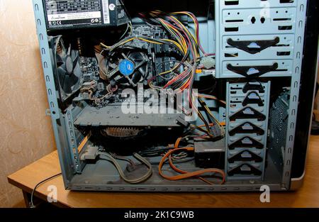 Dnepropetrovsk, Ukraine - 11.27.2021: A thick layer of dust covers the internal electronic components of the old computer, Thick dust on the electroni Stock Photo