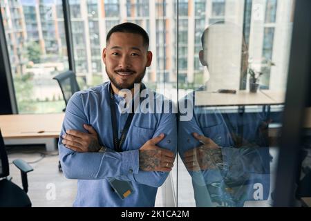 Joyous confident businessman posing for camera in workplace Stock Photo