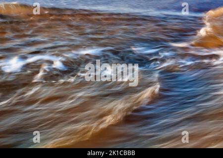 Waves on the beach, spray, agitated water in the evening light, dynamic, motion blur, stylized, illustration, Sylt, North Sea, Germany Stock Photo