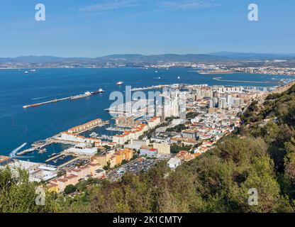 Gibraltar.  The town and part of the harbour seen from the upper slopes of the Rock.  In the distance, across the Bay of Algeciras (also known as the Stock Photo