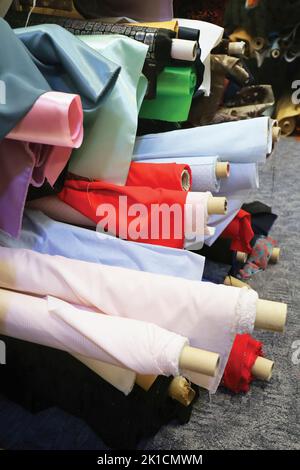 Rolls of material in a fabric shop. Stock Photo