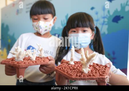 Children poses with 3D printed artificial reef structure during the press conference at the launch of coral restoration project by start-up archiREEF, Sino Group and Ocean Park. The project aims to rebuild local coral reefs in Hong Kong's southern waters and encourage secondary and primary school students to be ambassadors - 'CORAL REEFStoratorHH14SEP22   SCMP / Sam Tsang Stock Photo