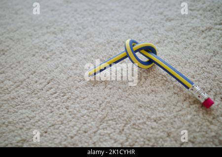 Twisted pencil on white fabric Stock Photo