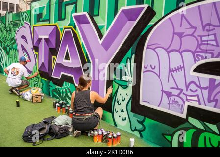 Southend City Jam event. Street artists displaying their skills at 60 locations around the city centre. Male and female artists painting. Stock Photo