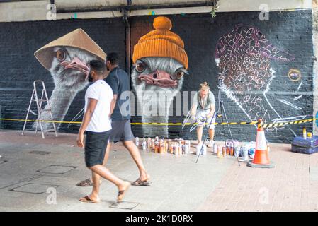 Southend City Jam event. Street artists displaying their skills at 60 locations around the city centre. People passing artist WOSKerski at work. Stock Photo