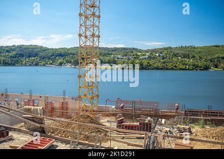 Workers at the construction site. Structural steel beam to build a large residential building on a construction site. Stock Photo