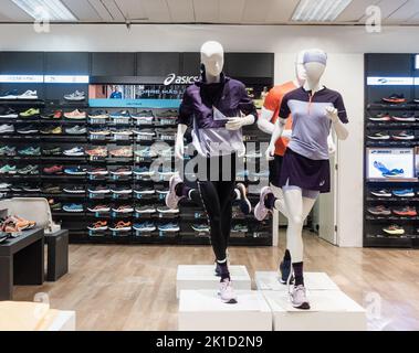 Asics footwear and clothing store display. Stock Photo