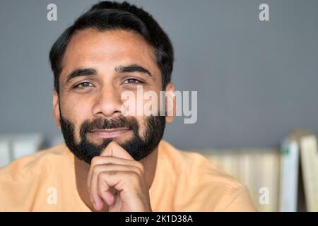 Indian ethnic bearded man looking at camera at home indoors. Close up portrait. Stock Photo