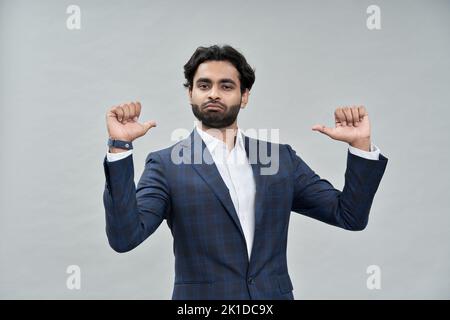Confident indian arab business man isolated on beige pointing at himself. Stock Photo