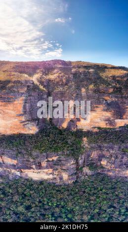Vertical panorama of deep steep rocky cliffs under Lincoln lookout in Blue Mountains of Australia. Stock Photo