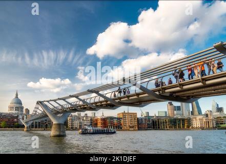 London South Bank,England,UK-Augst 21 2019:.On a fine,summer afternoon,tourists and workers walk across the iconic bridge,stopping to enjoy the view t Stock Photo
