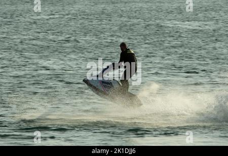 Water-sports man in wetsuit riding a jetski Stock Photo