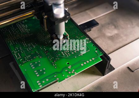 Soldering paste dispenser machine used on printed circuit board PCB surface. Machine production. Assembling parts. Horizontal shot. High quality photo Stock Photo