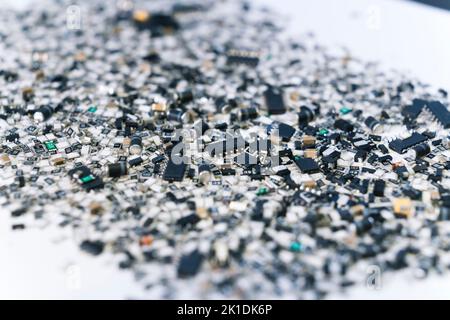 Close-up of messy scattered silver and black electronic parts for mounting on circuit board. Technological. Horizontal shot with blurred foreground. High quality photo Stock Photo