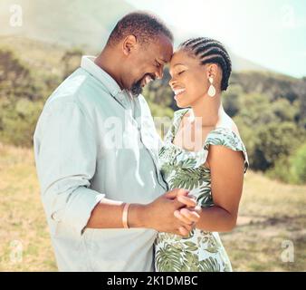 Black couple dancing in garden, park or nature together outdoors for love, relax and playful fun. African people, partners on a date and happy Stock Photo