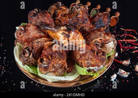 Roasting head of a lamb. Traditional Turkish Offal Food Kelle Sogus, Lamb Head Meat with Brain Served Portion served on a copper plate. Stock Photo