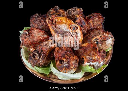 Roasting head of a lamb. Traditional Turkish Offal Food Kelle Sogus, Lamb Head Meat with Brain Served Portion served on a copper plate. Stock Photo