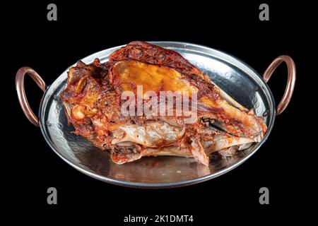 Roasting head of a lamb. Traditional Turkish Offal Food Kelle Sogus, Lamb Head Meat with Brain Served Portion served on a copper plate. Stock Photo