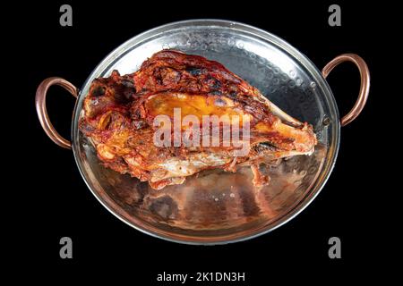 Roasting head of a lamb. Traditional Turkish Offal Food Kelle Sogus, Lamb Head Meat with Brain Served Portion served on a copper plate. Stock Photo