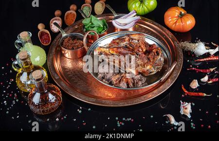 Roasting head of a lamb. Traditional Turkish Offal Food Kelle Sogus, Lamb Head Meat with Brain Served Portion served on a copper plate. Stock Photo