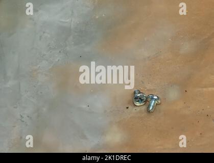 Two mounting bolts on the work surface. Close-up. Stock Photo