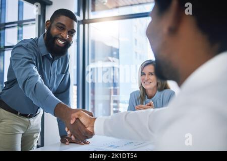 Deal, partnership and collaboration handshake of business people or men in b2b meeting at a diversity company. Happy smile of businessman shaking Stock Photo