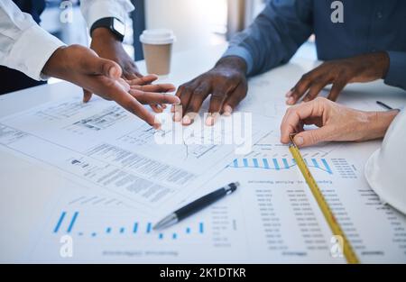 Hands, team and planning with an architect, engineer and designer meeting and in discussion over a construction document. Teamwork, building and Stock Photo