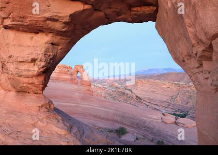 Delicate viewed through a natural window in Arch in Arches National Park, Utah, USA Stock Photo