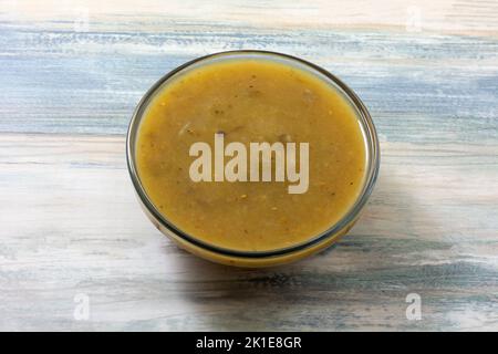 Salsa verde in glass ingredient bowl on table for cooking or as appetizer Stock Photo