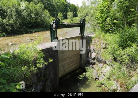 an old small sluice gate made of wood Stock Photo