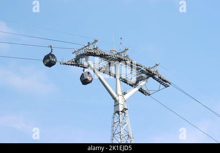 A low-angle shot of cable cars in Singapore on a cloudless day Stock Photo